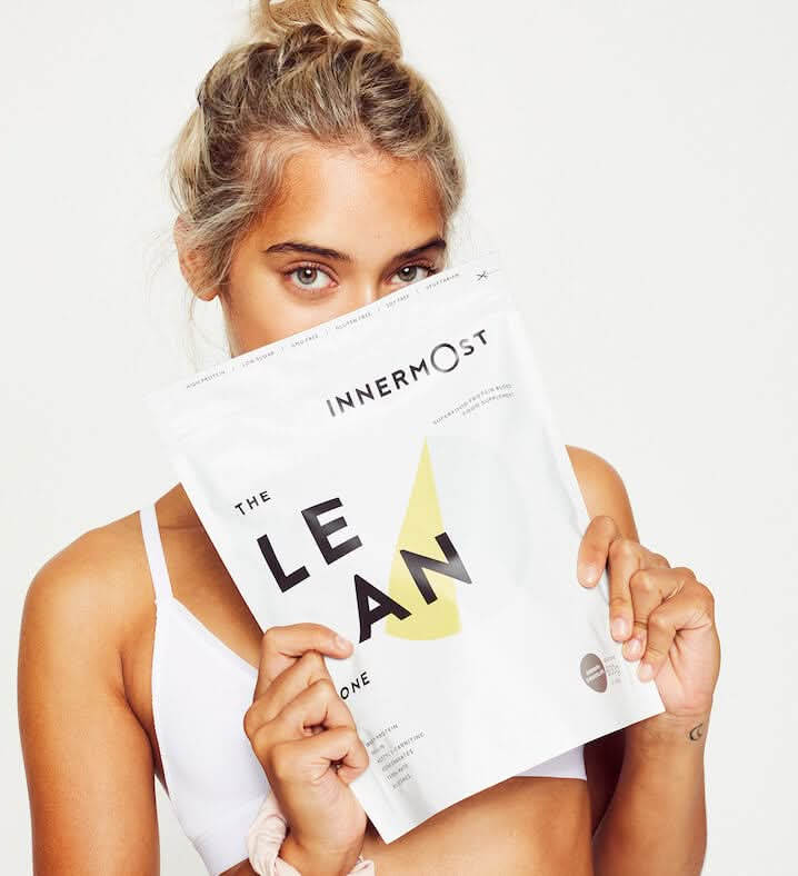 Ambar Driscoll holding a pouch of The Lean Protein - a whey protein powder developed by Innermost