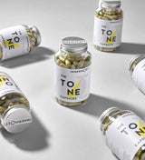 Jars of The Tone Capsules - a nutritional supplement for tone and definition, developed by Innermost